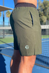 Neptune Athletics forest green mens shorts for tennis, gym, cross-training, with NEPTUNE vertical on left leg and Trident on back right leg