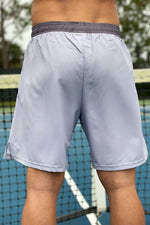 Neptune Comp Shorts - light gray with dark gray polka dots. White trident on front left leg. Use for tennis, gym, cross-training.